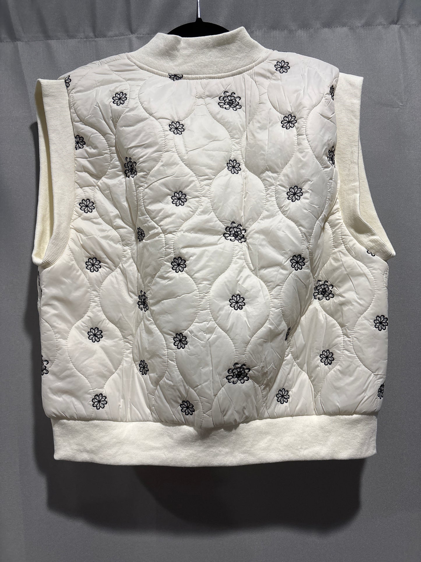 Quilted puffer vest with embroidered flowers