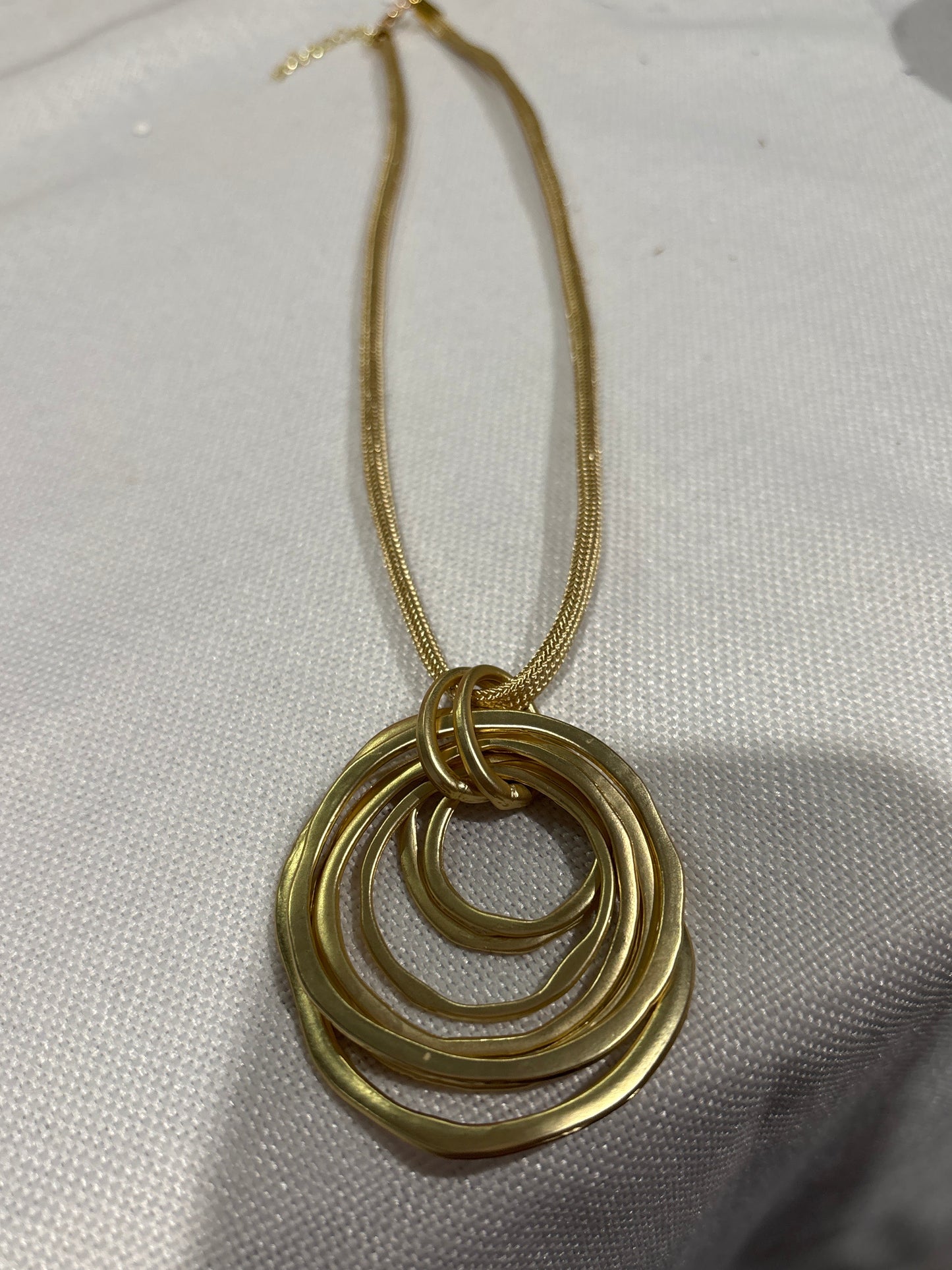 Brushed gold pendant with seven circles