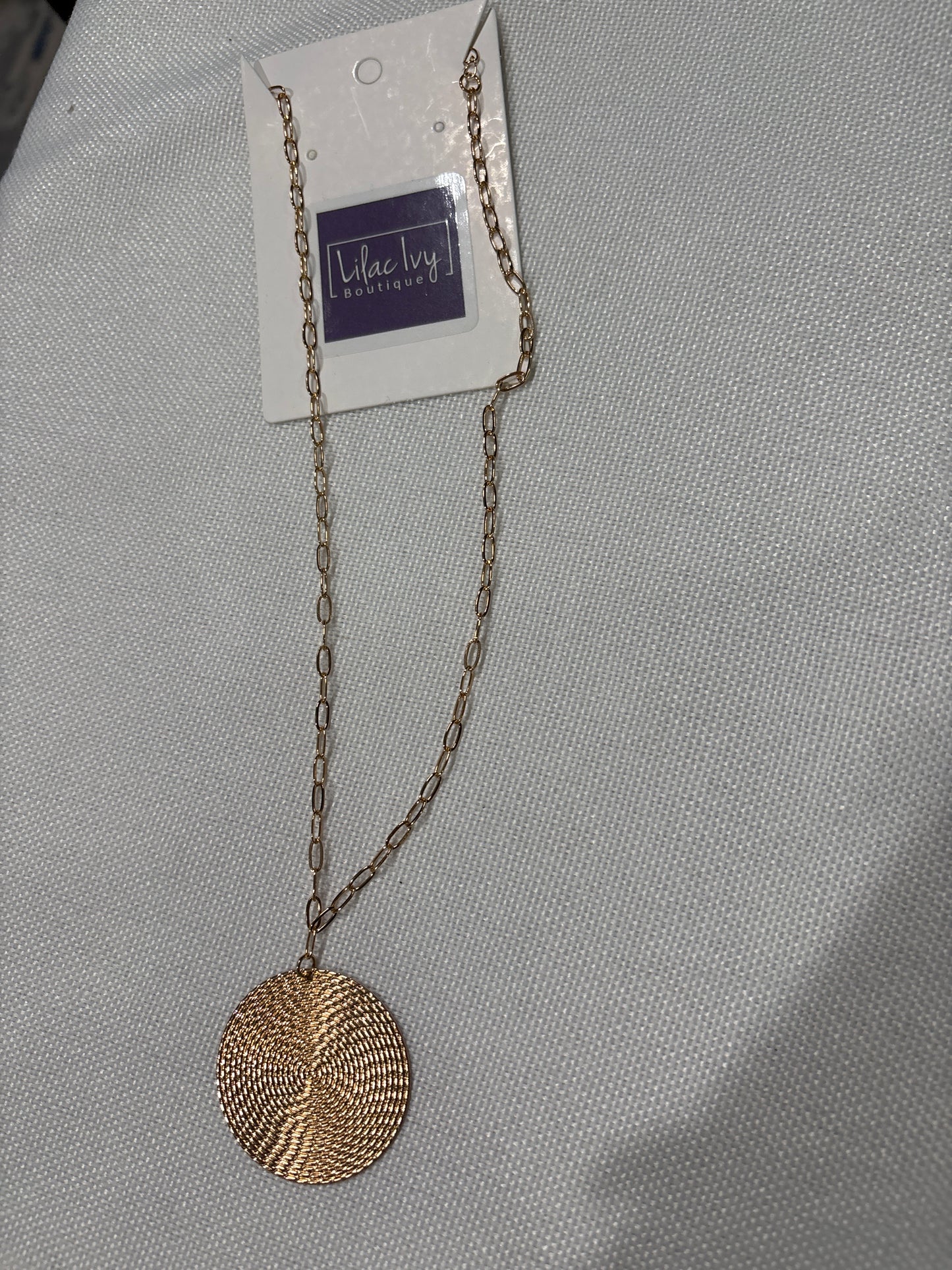 Hammered gold disc pendant