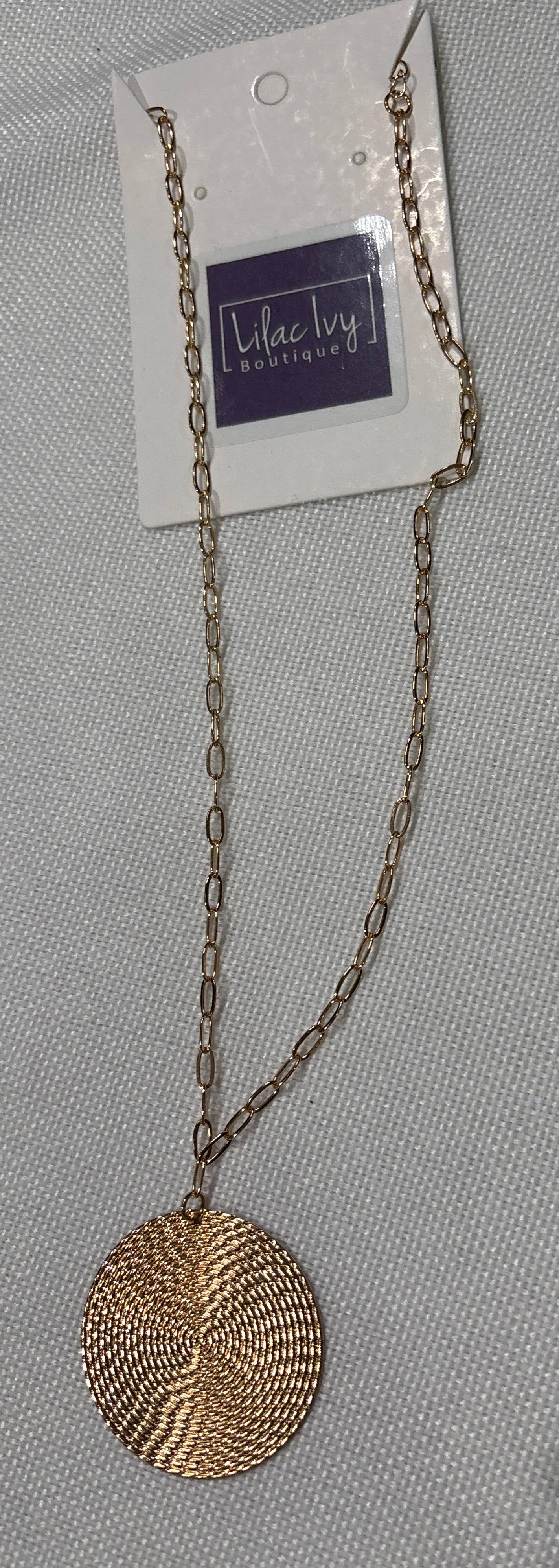 Hammered gold disc pendant