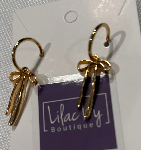 Gold bow on hoop earrings